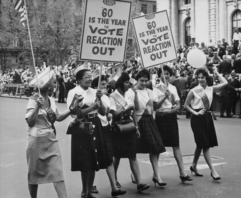 "ILGWU women marching in a Labor Day parade with placards that read, ''60 is the year to vote reaction out.'" 