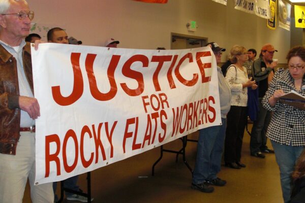 Protesters holding a banner that reads Justice for Rocky Flats Workers