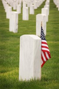 American flag next to tombstone